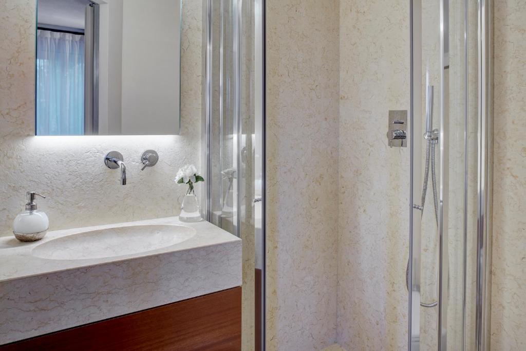 a bathroom with a sink and a shower at Il Leccio - Luxury Resort Portofino Monte in Santa Margherita Ligure