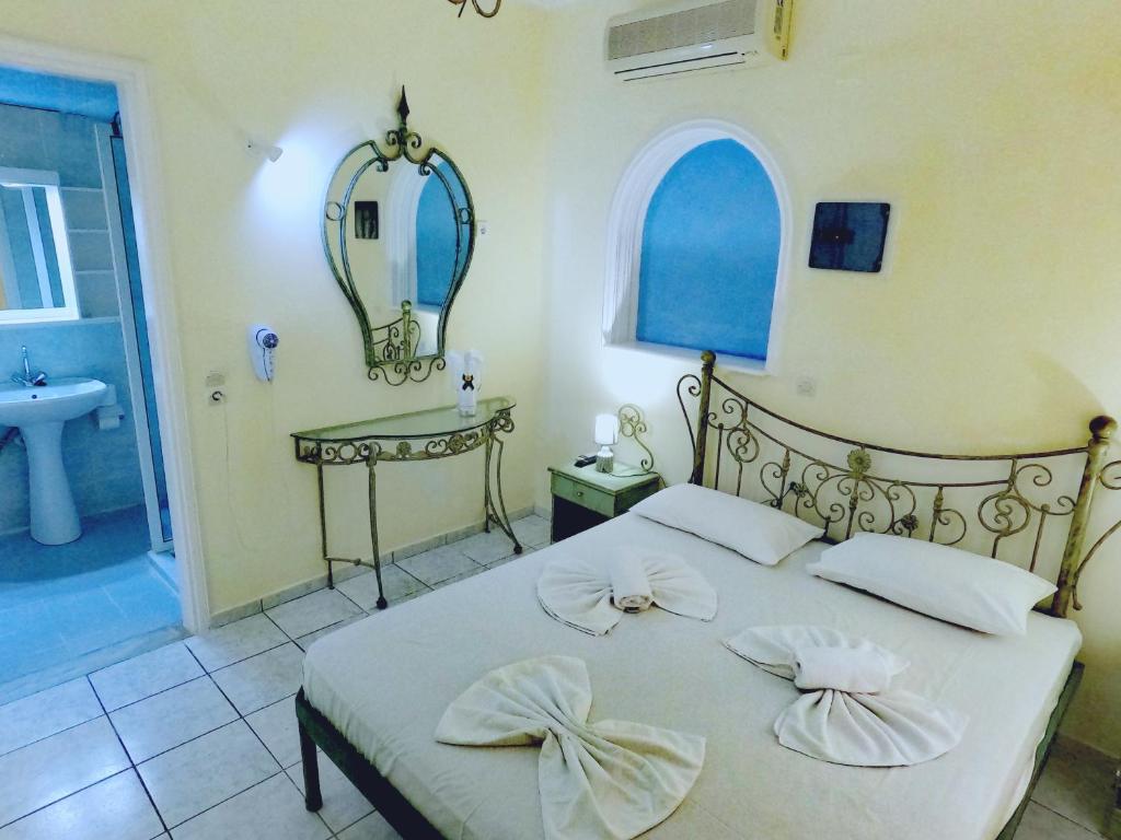 Postel nebo postele na pokoji v ubytování Palladion Hotel