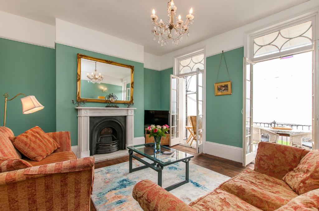 a living room with two couches and a fireplace at Seafront Regency Townhouse - Balcony Sea Views in Kent