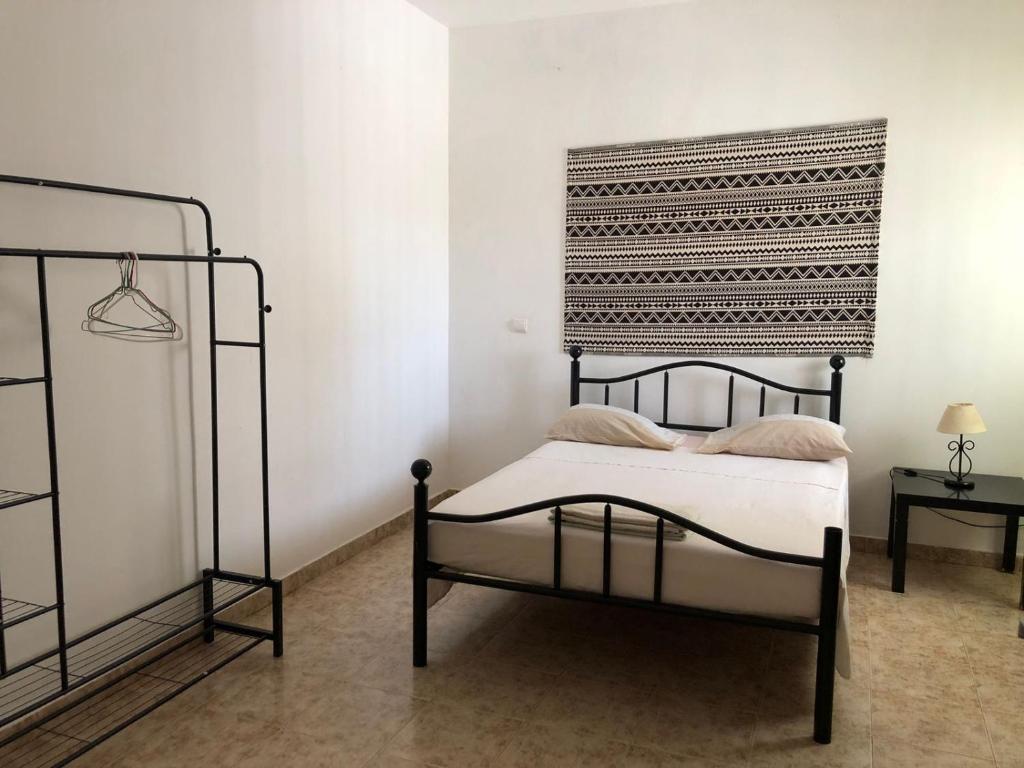 Postel nebo postele na pokoji v ubytování Tarrafal Ecodécor Rooms