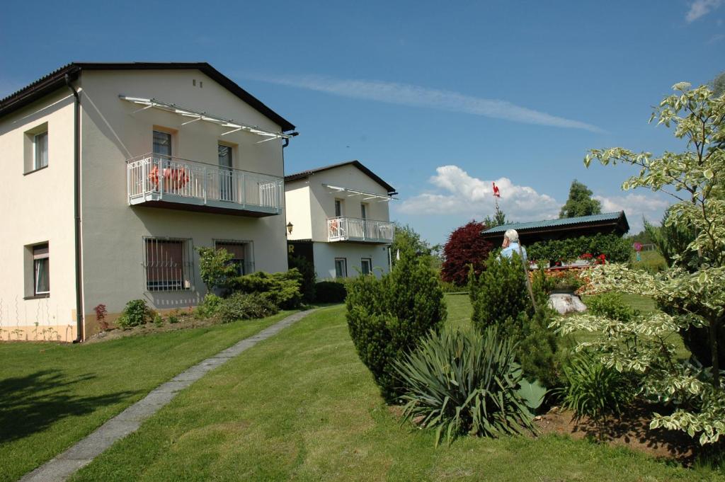 Una donna in piedi nel cortile di una casa di Haus Bärnthaler a Faak am See