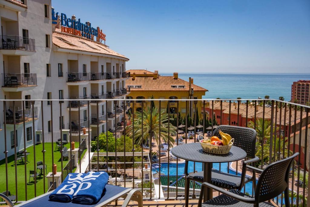 a balcony with a table and chairs and the ocean at Benalmadena Palace Spa in Benalmádena