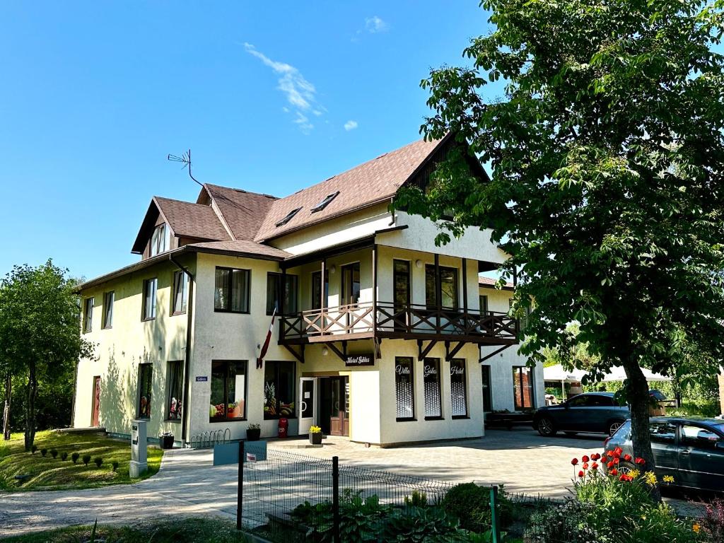 Villa Gāles Hotel في ساولكراستي: منزل فيه سيارة متوقفة أمامه