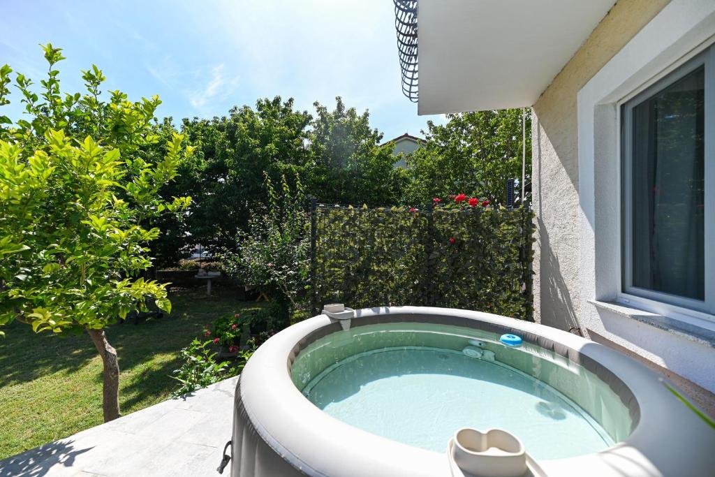 a bath tub in the backyard of a house at Apartmani Dolores in Kaštela