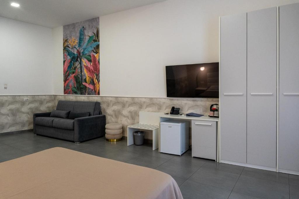 a living room with a couch and a chair at Hotel San Michele in Naples