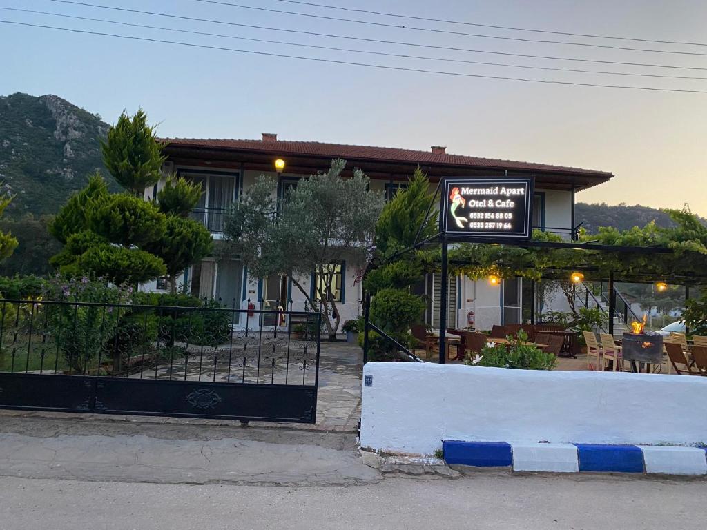 a restaurant with a sign in front of a building at Mermaid in Marmaris
