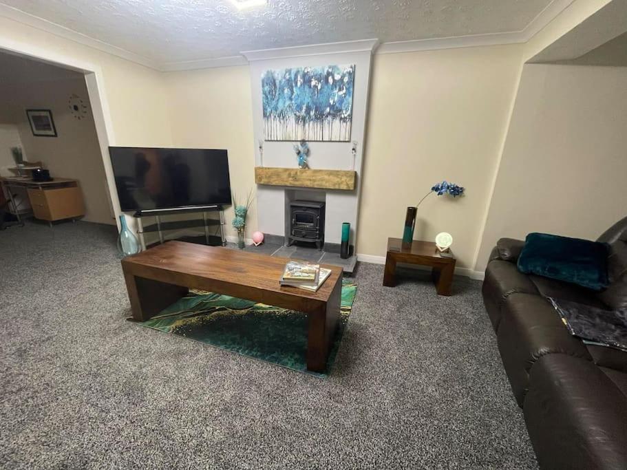 a living room with a couch and a coffee table at LeeVal Detached House parking in Stockton-on-Tees