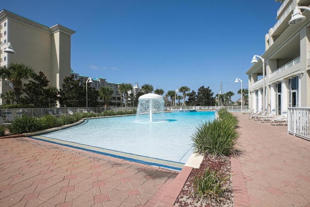 a swimming pool with a fountain in front of a building at Ariel Dunes I Unit 1209 Gulf view in Destin