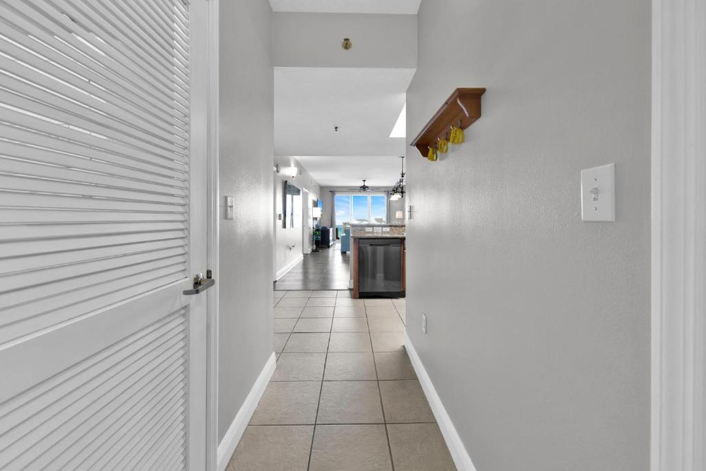 a hallway with white walls and a tile floor at Ariel Dunes I Unit 1209 Gulf view in Destin