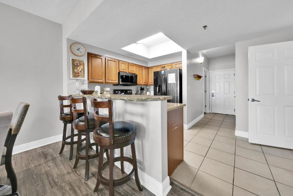 a kitchen with a counter and bar with stools at Ariel Dunes I Unit 1209 Gulf view in Destin