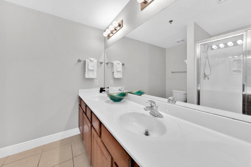 a white bathroom with a sink and a shower at Ariel Dunes I Unit 1209 Gulf view in Destin