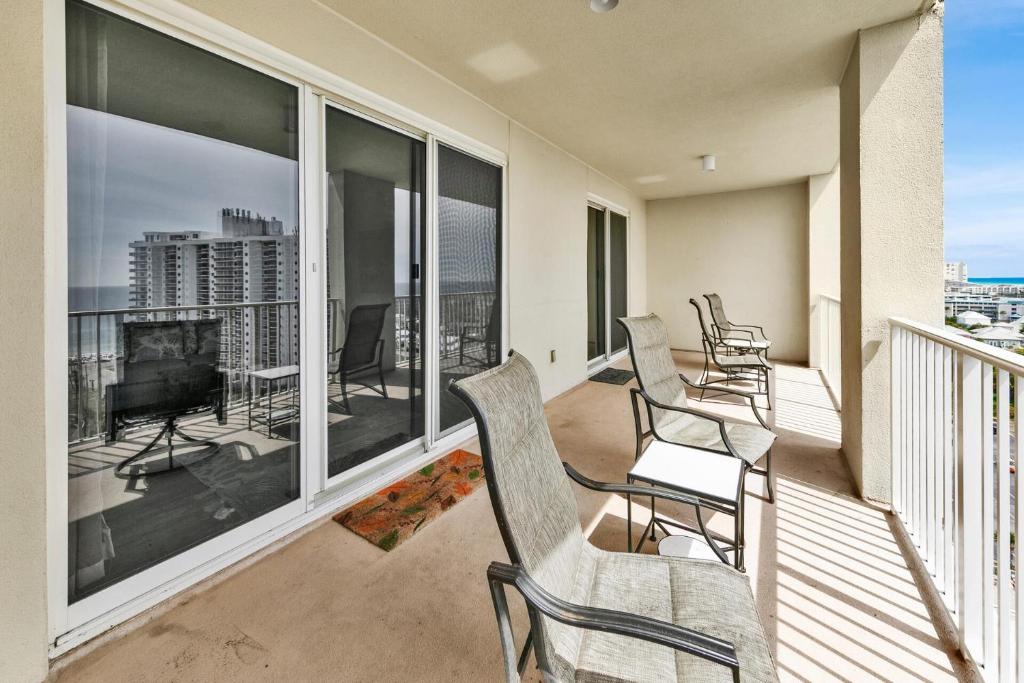 a balcony with chairs and a television on a balcony at Ariel Dunes I Unit 1209 Gulf view in Destin