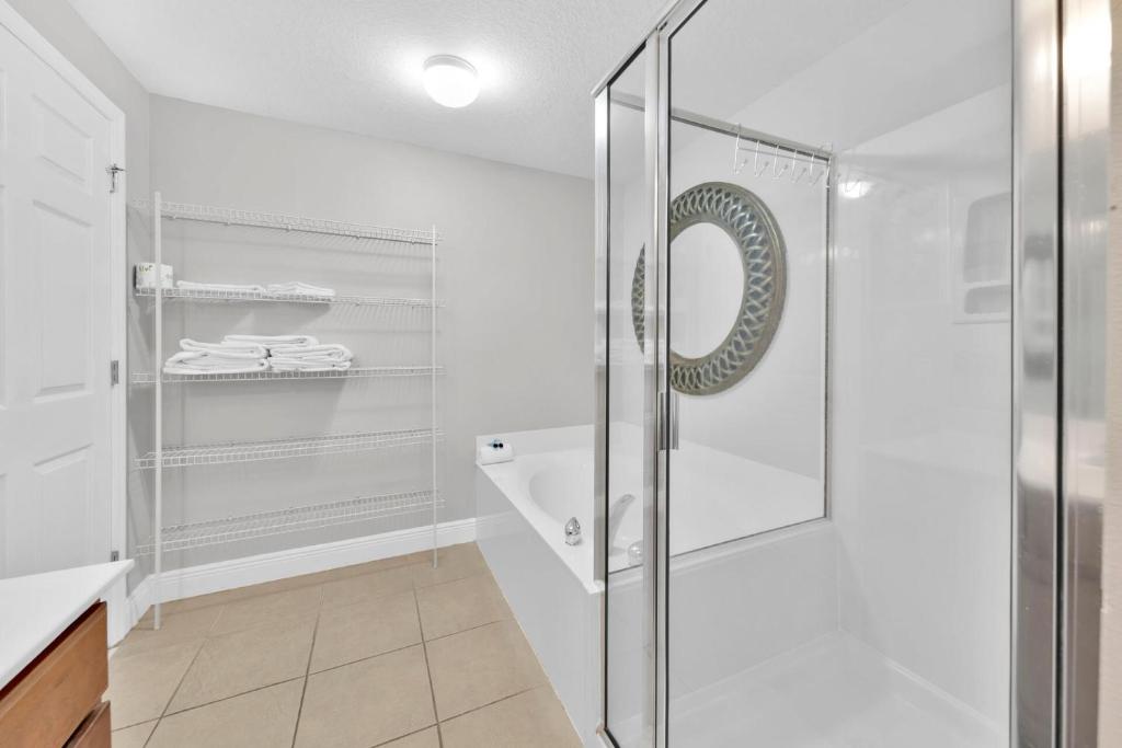 a bathroom with a glass shower and a sink at Ariel Dunes I Unit 1209 Gulf view in Destin
