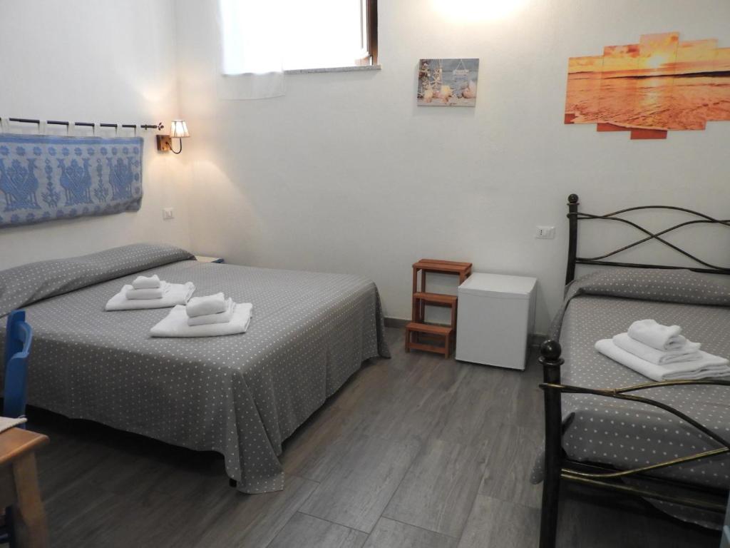 Postel nebo postele na pokoji v ubytování S'apposenteddu Affittacamere del Ristorante da Stefano