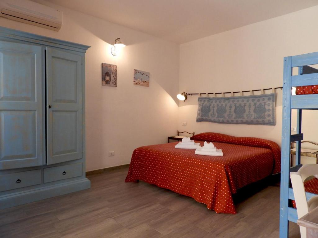 Postel nebo postele na pokoji v ubytování S'apposenteddu Affittacamere del Ristorante da Stefano