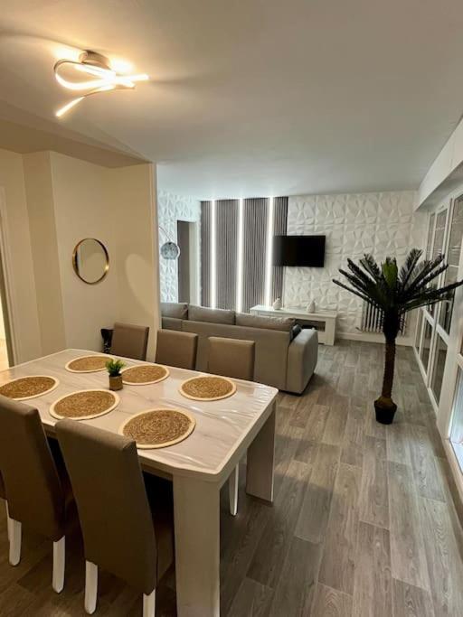 a living room with a white table and chairs at Le Tropical Home in Saint-Dizier