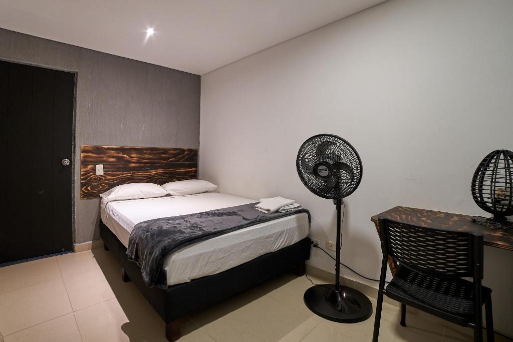 Postel nebo postele na pokoji v ubytování Hotel Express Medellin FARUM