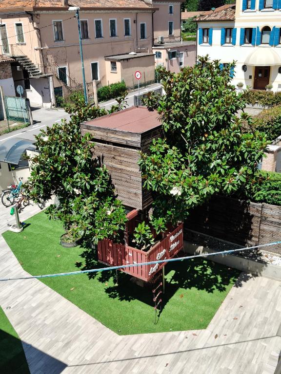 a small wooden house with two trees in it at HappyKids bb Venice in Campalto