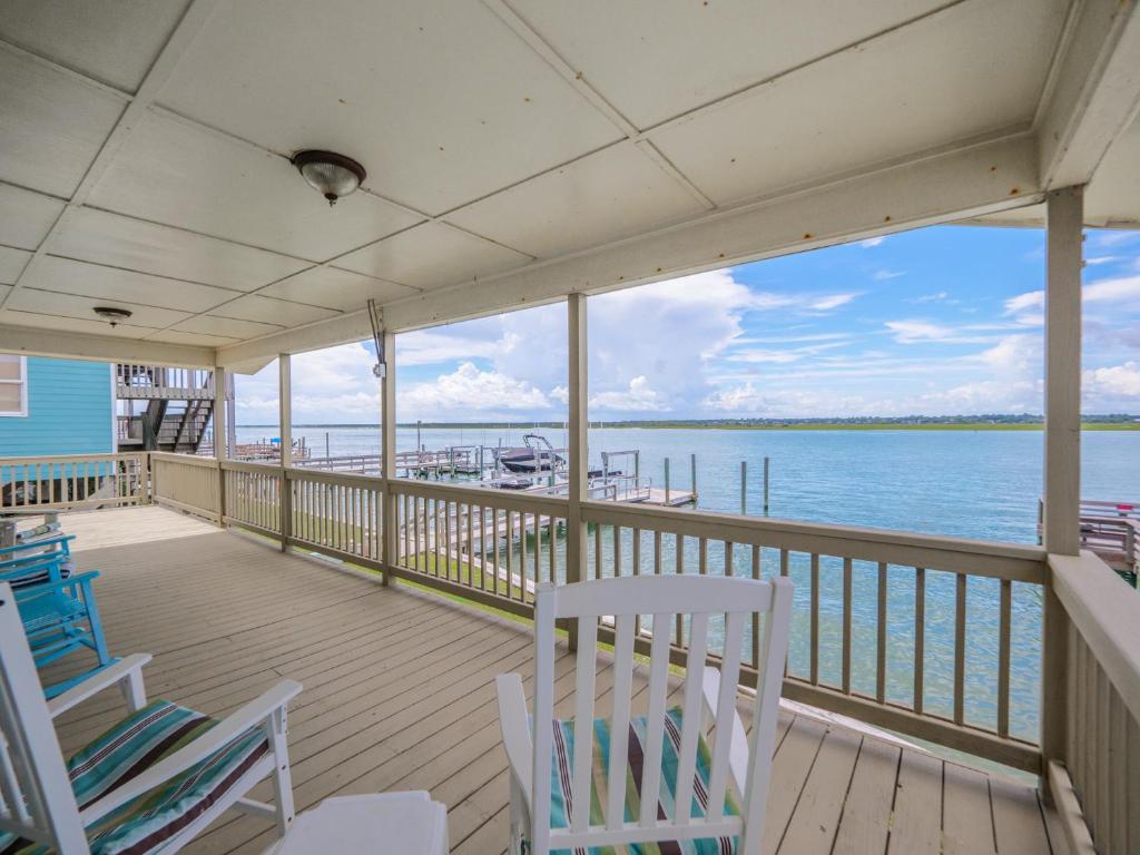 a porch with chairs and a view of the water at Seahorse Sound in Topsail Beach