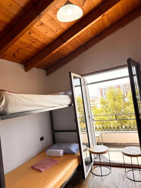 a room with a bunk bed and a window at Divina Hostel in Tirana