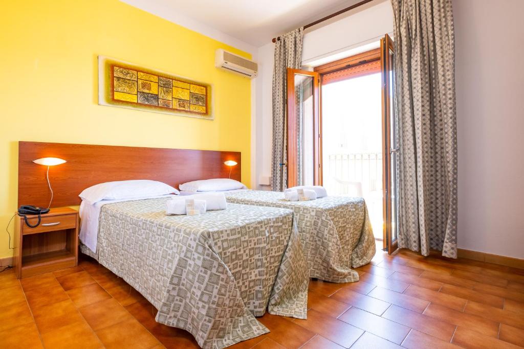 Postel nebo postele na pokoji v ubytování Hotel Il Gabbiano