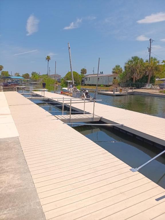 a dock with a boat in a body of water at Modern Waterview House in Hudson
