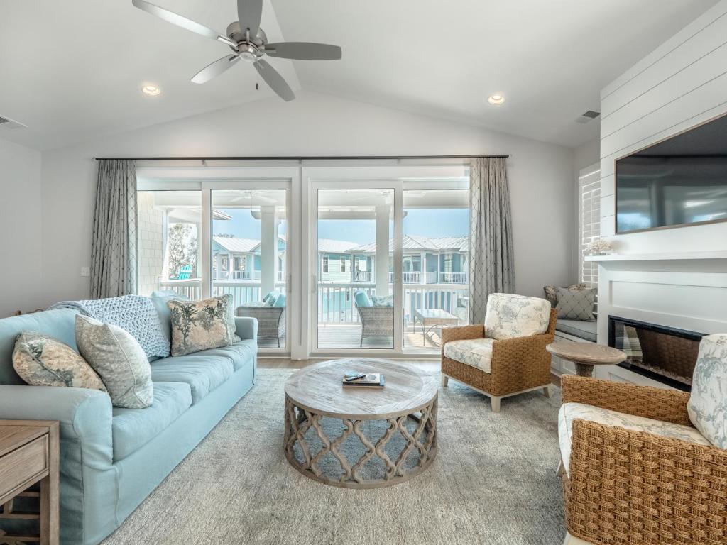 a living room with a couch and a table at Serenity By the Sea in Kure Beach