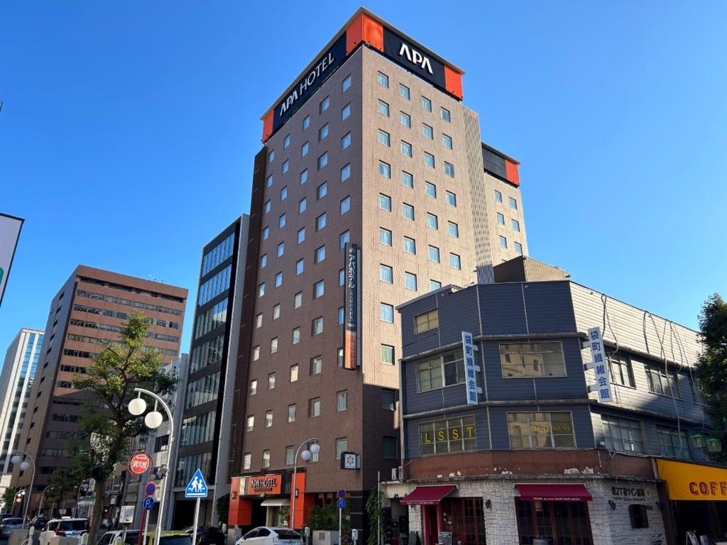 名古屋市にあるアパホテル名古屋伏見駅北の標識のある高層ビル