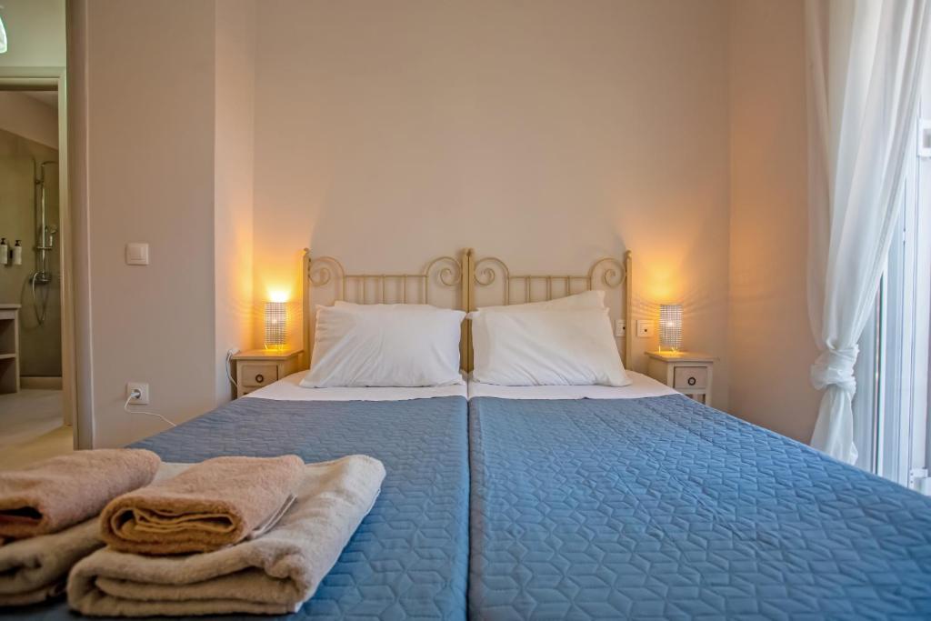 A bed or beds in a room at Cosmos Villas Spyridoula