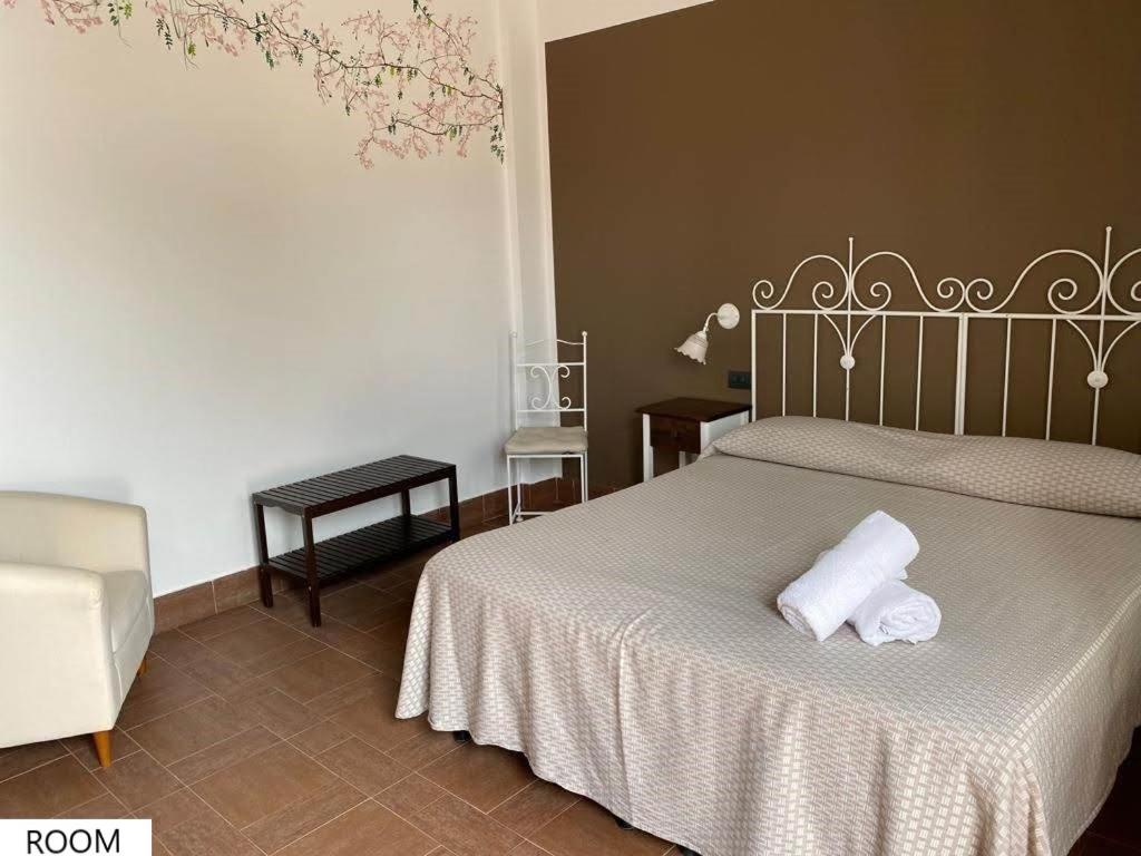 a bedroom with a bed with two towels on it at Tenute Plaia Agriturismo in Scopello