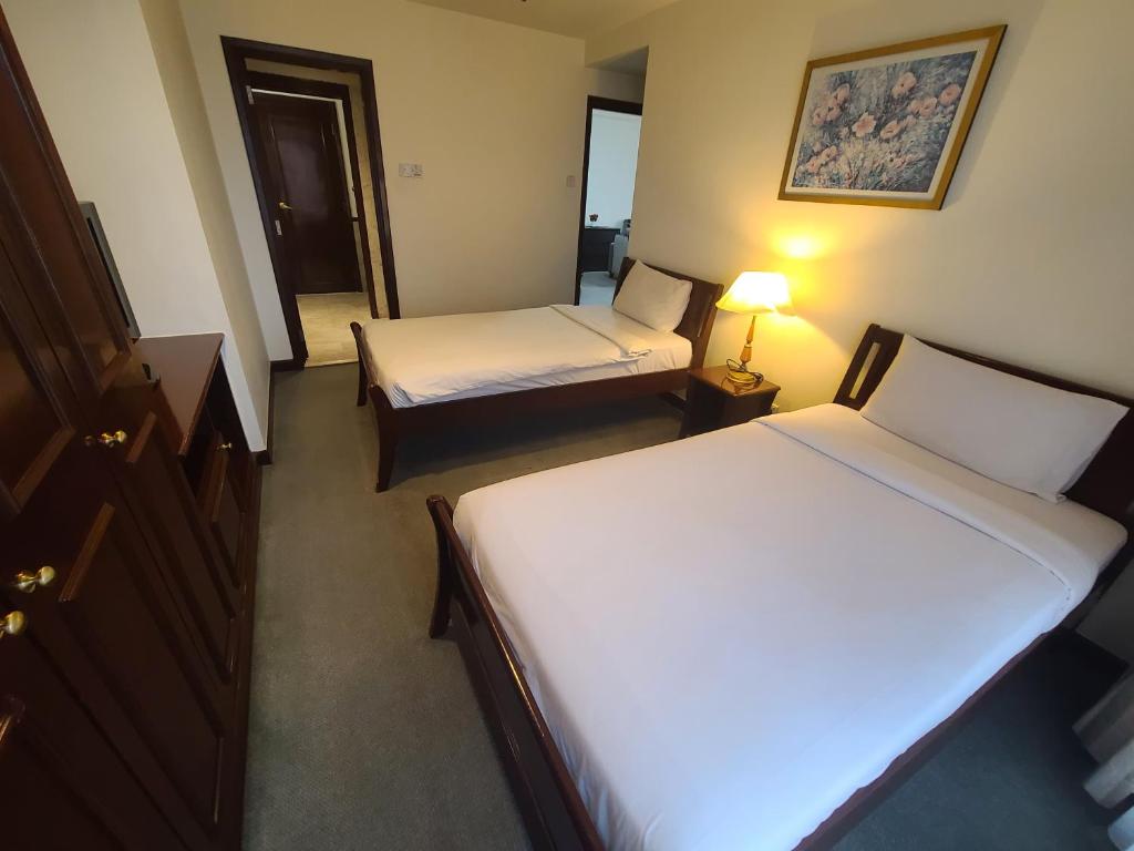 Postel nebo postele na pokoji v ubytování KL Time Square Hotal Sarvice Suite