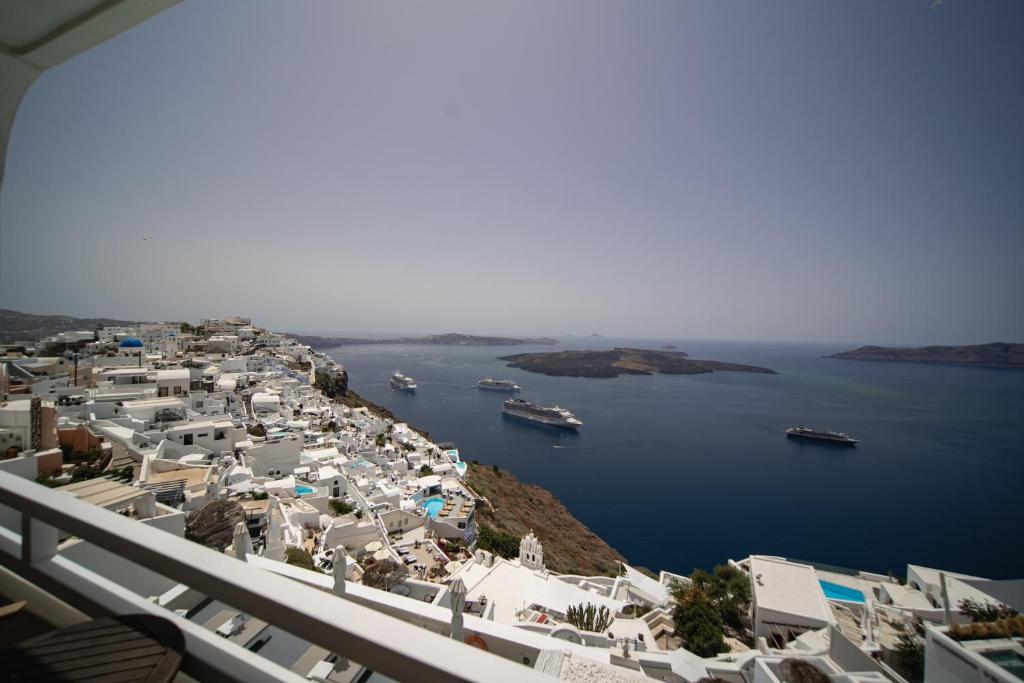 a view of a town with boats in the water at Villa Ilias in Firostefani