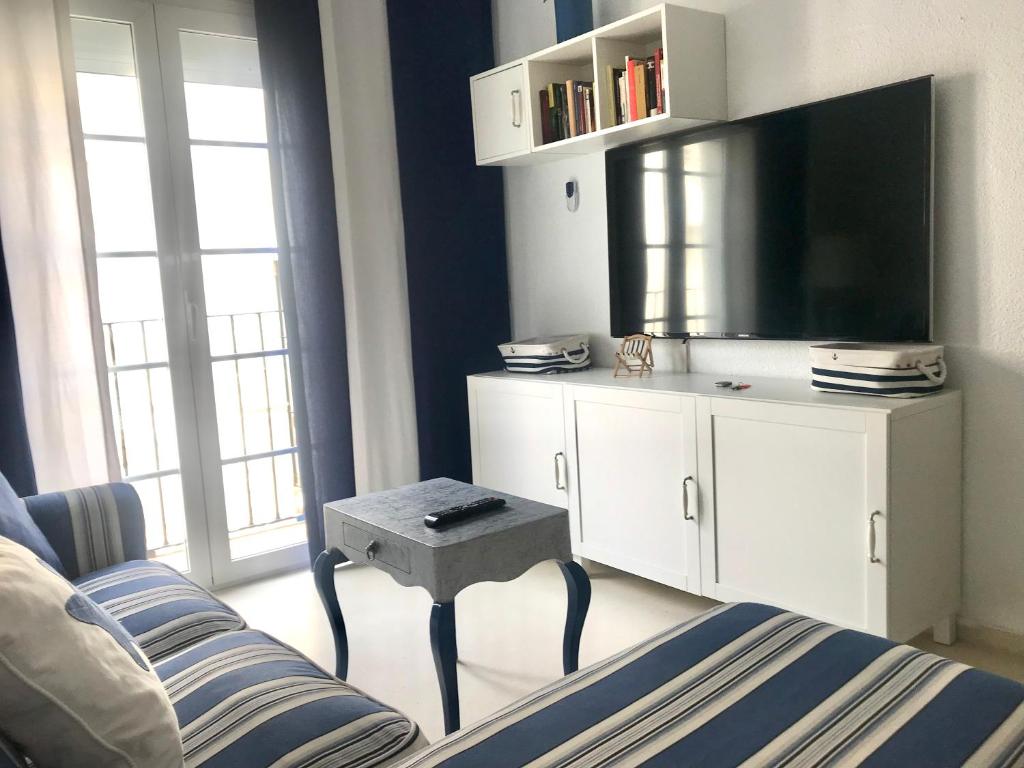 A television and/or entertainment centre at Apartamento DUPLEX CRUZ DEL MAR