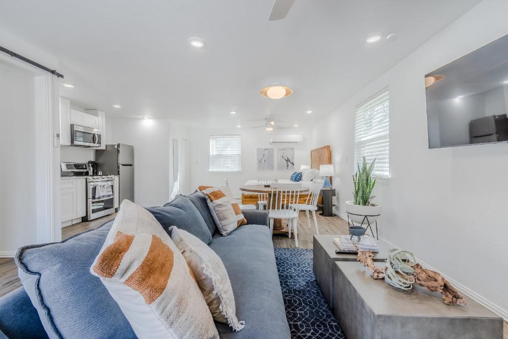 a living room with a blue couch and a table at Modern Studio Near Lake Lewisville Fire Pit & Pets OK by Vacation Your Way in Little Elm