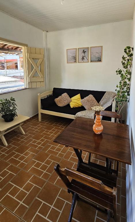 a living room with a couch and a table at Sunset Flats - Aconchengante Flat na Rua Pituba bem perto das Praias Urbanas! Itacare BA - PIT 1 in Itacaré