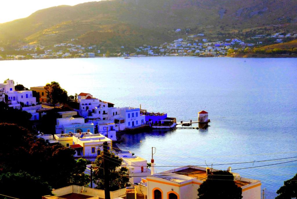 a view of a large body of water with buildings at ELEGEO rockhouse in Agia Marina