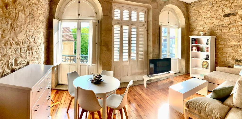 a living room with a table and chairs and a couch at Casa Varela en Noia in Noya