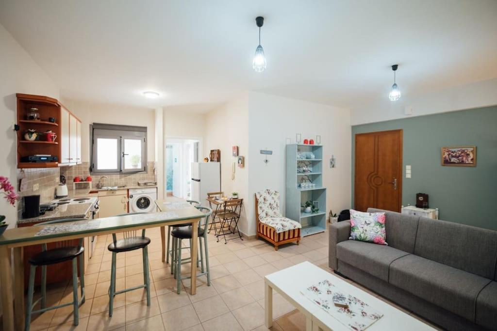 a kitchen and living room with a couch and a table at Dasillion Apartment by Alexia in Igoumenitsa