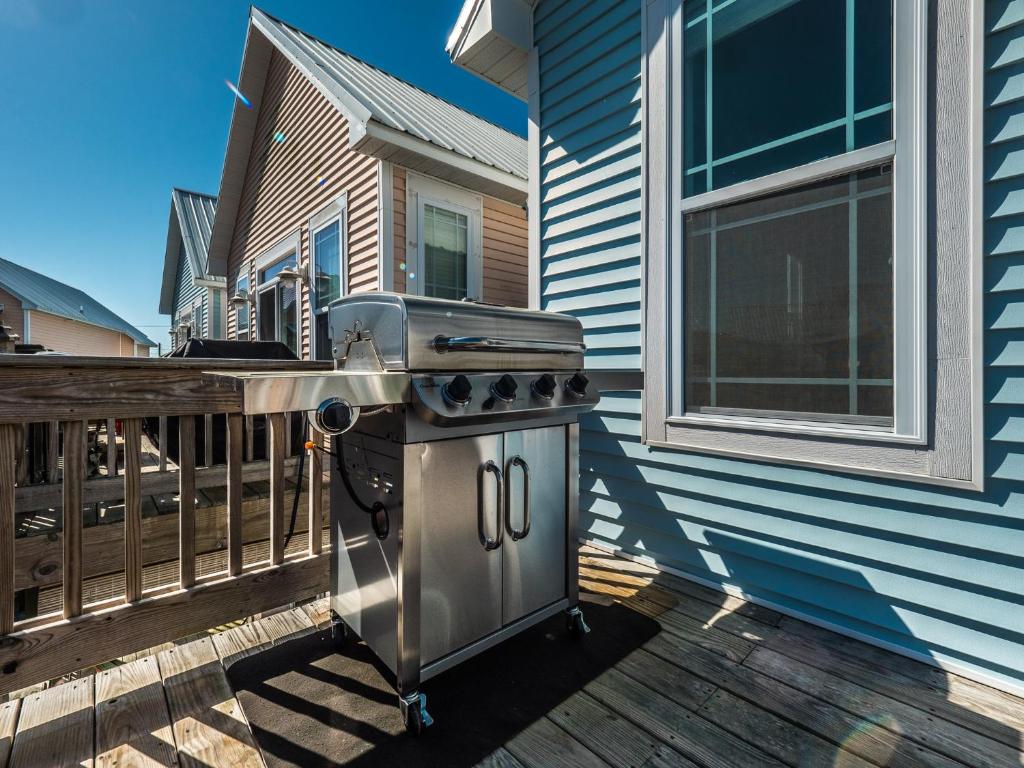 a grill on a deck next to a house at Sundancer in Surf City