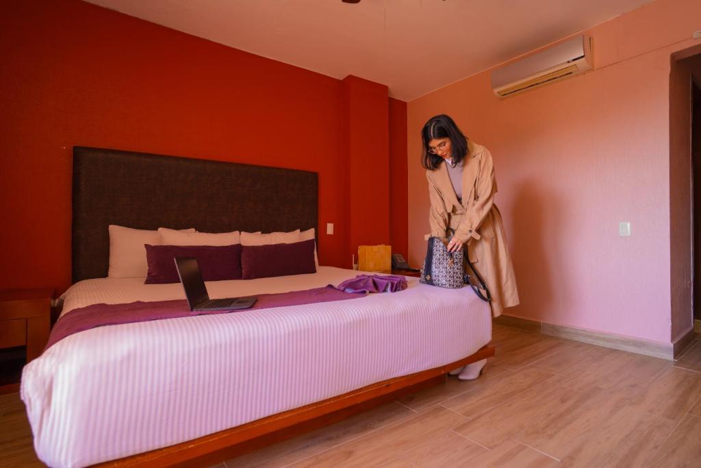 Postel nebo postele na pokoji v ubytování Hotel Suites Corazón Mexicano