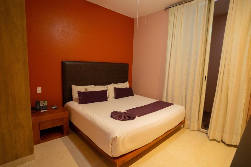 Postel nebo postele na pokoji v ubytování Hotel Suites Corazón Mexicano