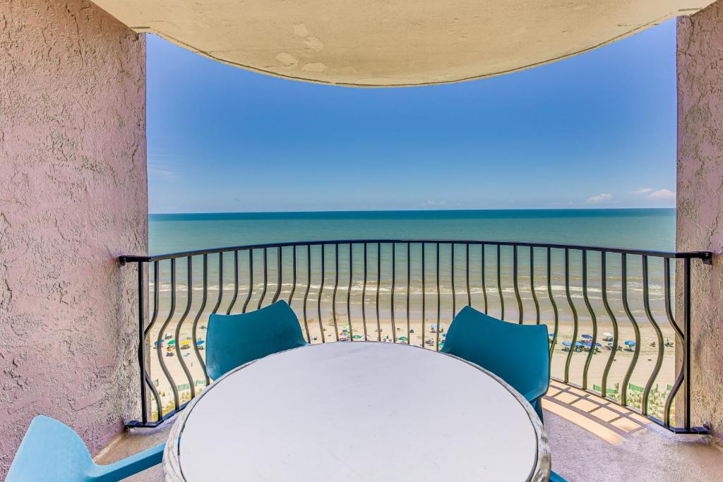 a table and chairs on a balcony with the ocean at Oceanfront Condo with Balcony in Myrtle Beach! in Myrtle Beach
