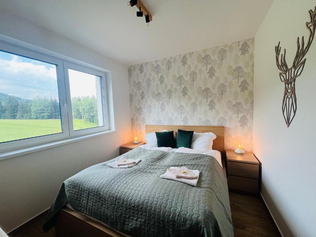Postel nebo postele na pokoji v ubytování Apartmán pod Špičákem