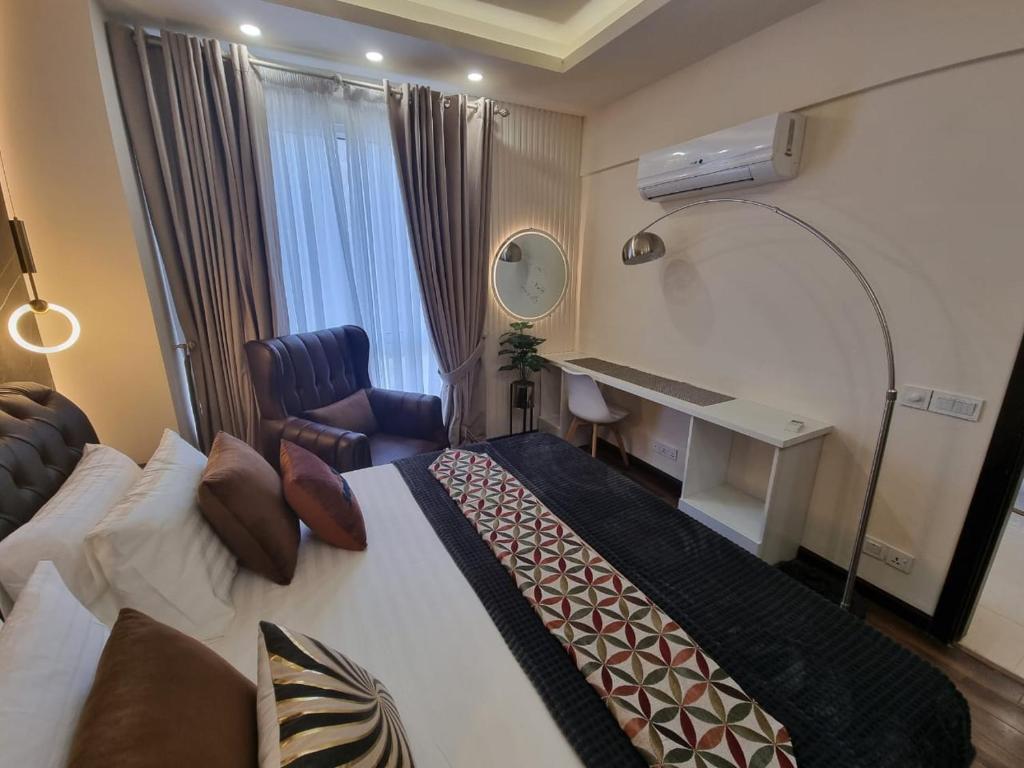 a hotel room with a bed and a desk at Elysium Service Apartment in Islamabad