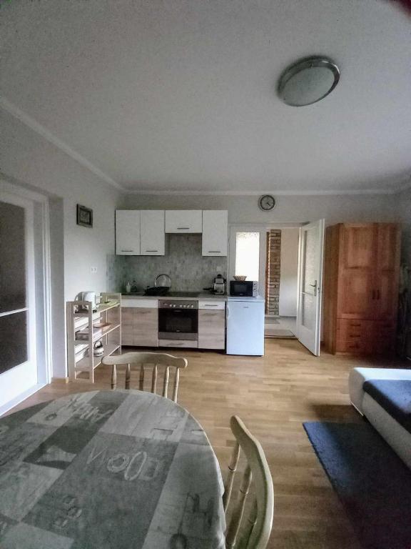 a kitchen with a table and chairs in a room at Bike&Night in Baracska