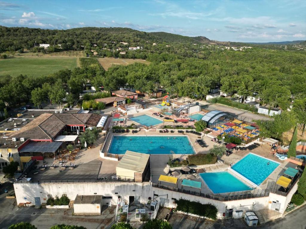 an aerial view of a resort with two pools at Mobil home climatisé 6pers. 3CH camping domaine de chaussy 5* Ardèche in Lagorce