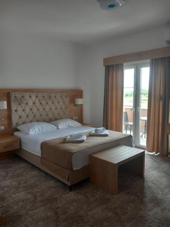a bedroom with a large bed and a large window at Haus Carla in Ulcinj