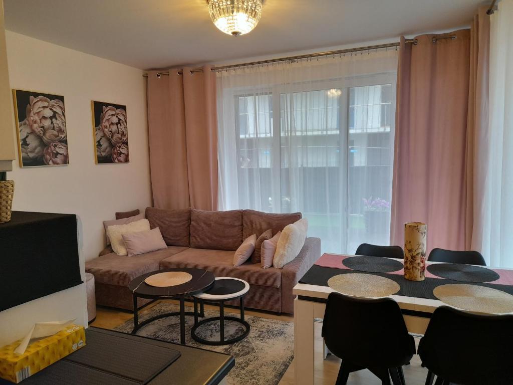 a living room with a couch and a table at Nadmorskie Apartamenty w Gąskach in Gąski