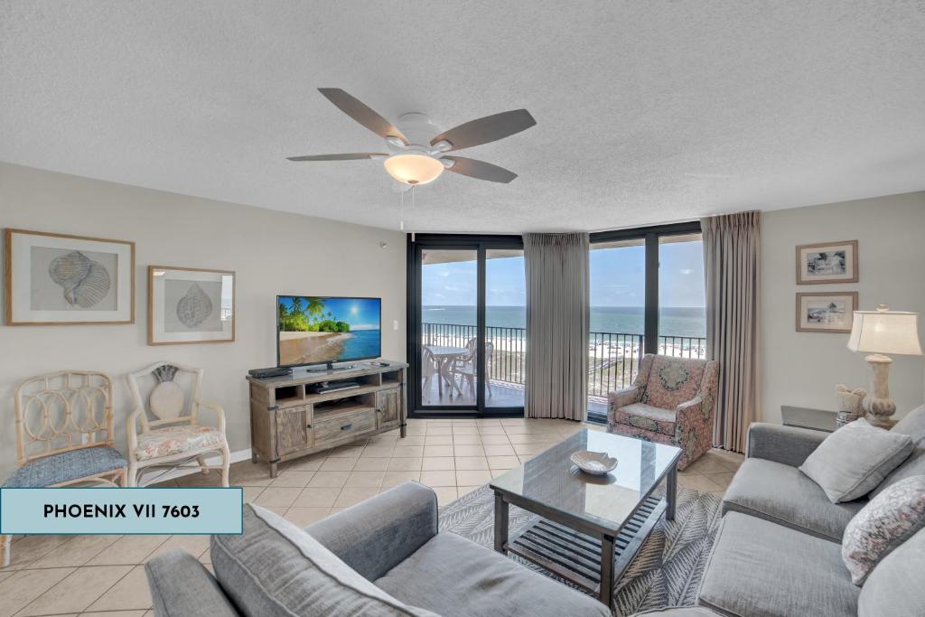a living room with a couch and a ceiling fan at Phoenix Vii 7603 in Orange Beach