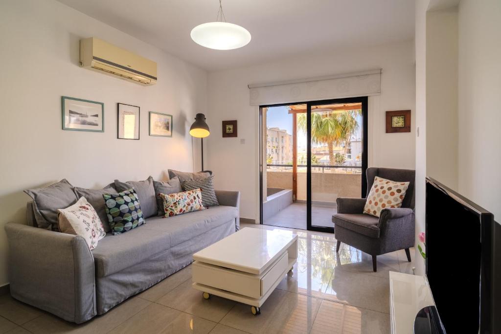 a living room with a couch and two chairs at Lazaros 1BDR Suite 3 min walk to Finikoudes beach in Larnaca